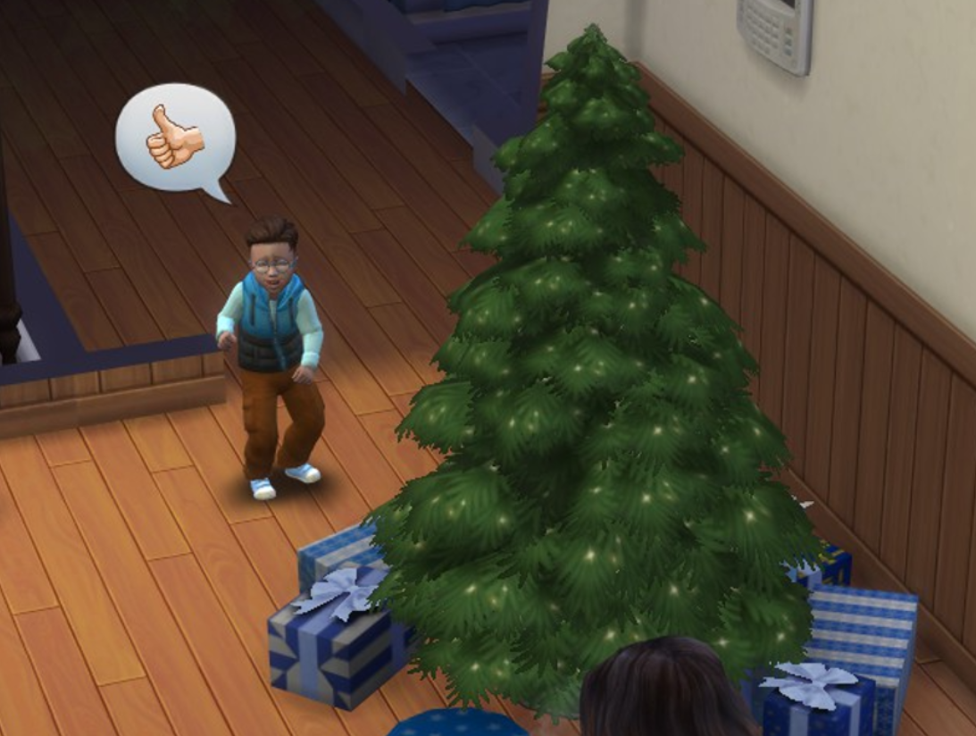 A Sims 4 screenshot, Etan crying while a speech bubble is above his head with a thumbs up emoji as he stands in front of a Christmas tree full of presents